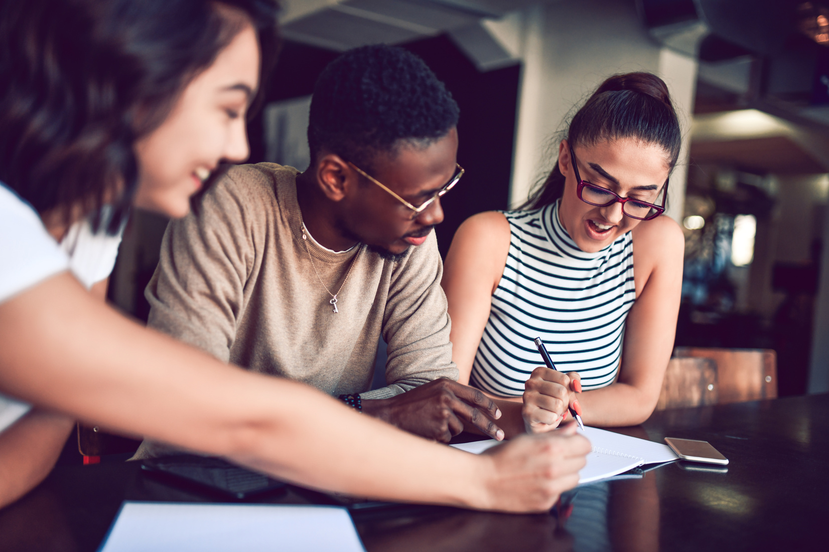 Multiethnic Friends Writing Homework Together